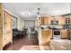 Open kitchen with light wood cabinets, stainless steel appliances, and breakfast bar at 381 Lake Rd, Idaho Springs, CO 80452