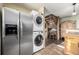 Stackable washer and dryer tucked away near kitchen and stairs at 381 Lake Rd, Idaho Springs, CO 80452