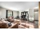 Living room with wood floors, a wood-burning stove, and leather sofas at 381 Lake Rd, Idaho Springs, CO 80452