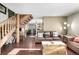 Cozy living room features wood floors and a view into the kitchen and dining area at 381 Lake Rd, Idaho Springs, CO 80452