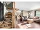 Cozy living room with wood-burning stove, leather couches, and wood floors at 381 Lake Rd, Idaho Springs, CO 80452