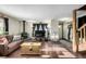 Living room with wood stove, wood floors and access to the entryway and stairs at 381 Lake Rd, Idaho Springs, CO 80452