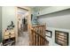 Upstairs hall with wooden railing and access to bedrooms at 381 Lake Rd, Idaho Springs, CO 80452