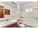 The bathroom features white tile, a large mirror, tub, and wood vanity at 6930 Warren Dr, Denver, CO 80221