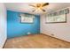 Cozy bedroom featuring carpet, a ceiling fan, and natural light from two windows at 6930 Warren Dr, Denver, CO 80221