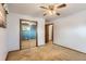 Neutral bedroom featuring ceiling fan, closet with mirrored doors, and access to an adjacent room at 6930 Warren Dr, Denver, CO 80221