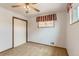 Bedroom with neutral carpeting, a ceiling fan, and closet space at 6930 Warren Dr, Denver, CO 80221
