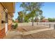 Street view of a charming home with low-maintenance gravel landscaping and a chain-link fence at 6930 Warren Dr, Denver, CO 80221