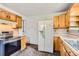 Bright kitchen with wood cabinets, appliances and a functional layout for cooking and food preparation at 6930 Warren Dr, Denver, CO 80221