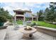 Backyard boasts tiered landscaping, a stone fire pit, and a covered patio, perfect for outdoor entertaining at 8337 Greenwood Dr, Niwot, CO 80503