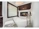 Modern bathroom featuring a freestanding tub, a fireplace, and a glass block window, creating a luxurious spa-like atmosphere at 8337 Greenwood Dr, Niwot, CO 80503