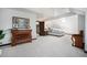 Large bedroom with an angled ceiling, featuring a dresser and bedside table with a view through the doorway at 8337 Greenwood Dr, Niwot, CO 80503