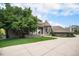 Beautiful home exterior featuring a brick facade, turret, and a spacious driveway with mature landscaping at 8337 Greenwood Dr, Niwot, CO 80503