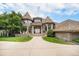 Elegant brick home features a turret-style design, manicured lawn, and a welcoming entrance, creating a grand curb appeal at 8337 Greenwood Dr, Niwot, CO 80503