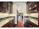 Elegant hallway features marble countertops, custom cabinetry and hardwood floors at 8337 Greenwood Dr, Niwot, CO 80503