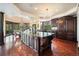 Gourmet kitchen with dark wood cabinetry, granite countertops, and a chandelier, offering a luxurious cooking experience at 8337 Greenwood Dr, Niwot, CO 80503