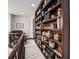 Upper-level library with floor-to-ceiling built-in bookshelves, dark wood trim, and a cozy reading nook at 8337 Greenwood Dr, Niwot, CO 80503