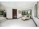 Bright living room with a chaise lounge near a window with green outdoor scenery with a wooden framed door at 8337 Greenwood Dr, Niwot, CO 80503