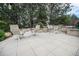 Large patio area with multiple seating arrangements, perfect for outdoor entertaining with stone surround at 8337 Greenwood Dr, Niwot, CO 80503
