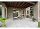 Covered patio with brick columns and two wicker chairs, offering a relaxing outdoor seating area at 8337 Greenwood Dr, Niwot, CO 80503