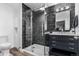 Modern bathroom with dark tile shower and floating vanity at 3460 W 131St Ave, Broomfield, CO 80020