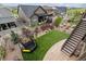 Aerial view of a backyard featuring green lawn, trampoline, landscaping, and patio area at 8107 Arapahoe Peak St, Littleton, CO 80125