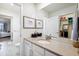Bright bathroom with double vanity, large mirror, and walk-in closet at 8107 Arapahoe Peak St, Littleton, CO 80125