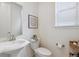Cozy half bathroom with pedestal sink, modern fixtures, and decorative accents at 8107 Arapahoe Peak St, Littleton, CO 80125