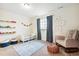 Cozy bedroom with toy display shelves and comfortable seating area at 8107 Arapahoe Peak St, Littleton, CO 80125