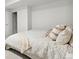 Cozy bedroom featuring a bed with decorative pillows and a doorway to an ensuite bathroom at 8107 Arapahoe Peak St, Littleton, CO 80125
