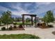 A community park with a picnic bench, gazebo and playground equipment, surrounded by green space at 8107 Arapahoe Peak St, Littleton, CO 80125