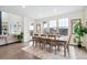 Elegant dining room with large table, ample seating, and abundant natural light at 8107 Arapahoe Peak St, Littleton, CO 80125