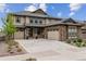 Two-story house with stone and siding exterior, two-car garage, and landscaping at 8107 Arapahoe Peak St, Littleton, CO 80125