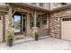 Inviting front entrance with stone pillars, glass door and welcome mat at 8107 Arapahoe Peak St, Littleton, CO 80125