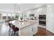 Spacious kitchen island with pendant lighting, stainless steel sink, and modern faucet at 8107 Arapahoe Peak St, Littleton, CO 80125