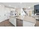 Bright kitchen with large island, stainless appliances, and modern accents at 8107 Arapahoe Peak St, Littleton, CO 80125