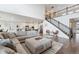 Open concept living room with hardwood floors, sectional sofa, and fireplace at 8107 Arapahoe Peak St, Littleton, CO 80125