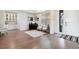 Bright living room with hardwood floors, piano, and built-in shelving at 8107 Arapahoe Peak St, Littleton, CO 80125