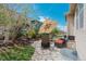 Backyard featuring a stone patio with outdoor seating, lush lawn, and mature trees at 5741 Echo Park Cir, Castle Rock, CO 80104