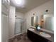 Bright bathroom with double sinks, glass-enclosed shower, and tiled floor at 5741 Echo Park Cir, Castle Rock, CO 80104