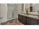 Bathroom with a double sink vanity, a glass enclosed shower, and modern fixtures at 5741 Echo Park Cir, Castle Rock, CO 80104