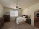 Cozy bedroom with ceiling fan, natural light, and view to living room beyond doorway at 5741 Echo Park Cir, Castle Rock, CO 80104