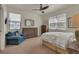 Bright bedroom with a comfortable bed, wood furniture, and a cozy sitting area with a blue chair at 5741 Echo Park Cir, Castle Rock, CO 80104