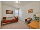 Comfortable bedroom featuring a futon, wicker chair, desk, and natural light at 5741 Echo Park Cir, Castle Rock, CO 80104