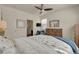 Bright bedroom featuring a ceiling fan, a wooden dresser and a cozy sitting area at 5741 Echo Park Cir, Castle Rock, CO 80104