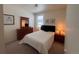 Comfortable bedroom features neutral tones, dresser, side tables, and a bright window at 5741 Echo Park Cir, Castle Rock, CO 80104
