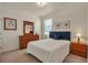 Relaxing bedroom with natural light, wood furnishings, and a plush blue headboard at 5741 Echo Park Cir, Castle Rock, CO 80104