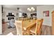 Open dining room with hardwood floors, a wooden table, and a view of the living room and kitchen at 5741 Echo Park Cir, Castle Rock, CO 80104