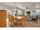 Well-lit dining area with a wooden table, chairs, and a view of the fireplace in the living room at 5741 Echo Park Cir, Castle Rock, CO 80104