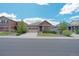 Charming single-Gathering home featuring a stone facade, well-maintained lawn, and a two-car garage at 5741 Echo Park Cir, Castle Rock, CO 80104